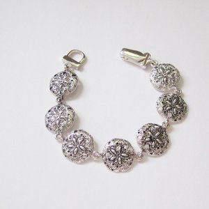 Burnished silver tone metal sand dollar bracelet
